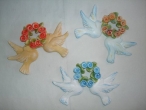 Hand-painted ceramic pigeons with wreath.
